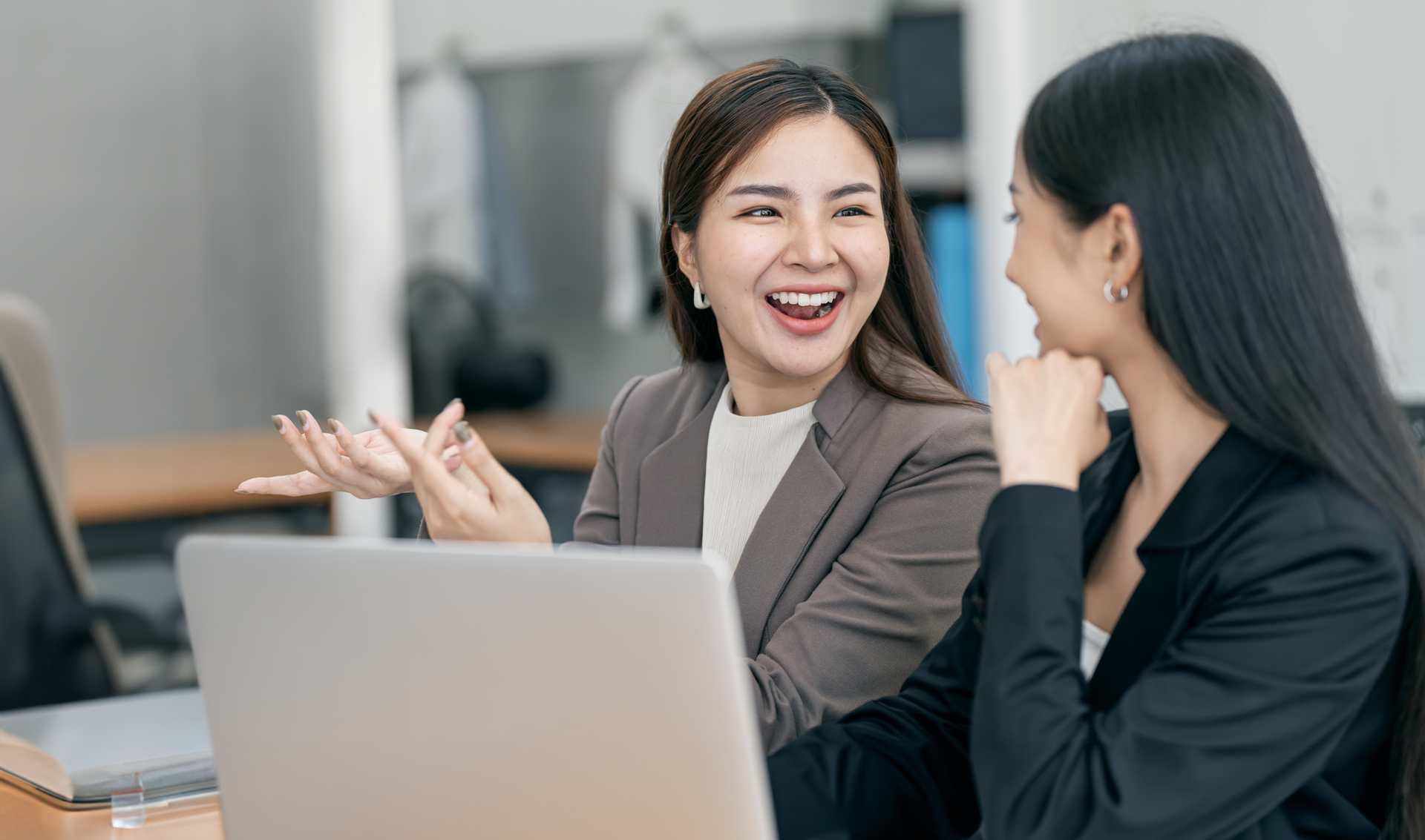 Two young asian businesswoman discuss with new startup project idea presentation analyze planning financial statistics investment market office1